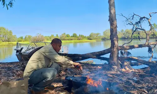 Gerald Danao preparing lunch around the campfire.