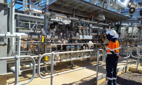 Officers inspect new pollution control and emissions monitoring equipment at an LNG facility.